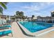 Inviting community pool with lounge chairs and patio tables at 109 Madrid Dr # 109, Casselberry, FL 32707