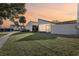 Evening view of townhouse with grassy area and screened patio at 109 Madrid Dr # 109, Casselberry, FL 32707