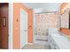 Bathroom featuring a shower/tub combo, double vanity, and peach walls at 1107 Seafarer Ln, Winter Springs, FL 32708