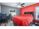 Red-themed bedroom with a large bed and workspace at 1107 Seafarer Ln, Winter Springs, FL 32708