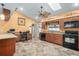 Kitchen with granite countertops, black appliances, and wood cabinets at 1107 Seafarer Ln, Winter Springs, FL 32708