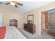 Main bedroom with ensuite bathroom, dresser, and a king-size bed at 1107 Seafarer Ln, Winter Springs, FL 32708