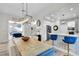 Kitchen and dining area with a rustic farmhouse table and blue velvet seating at 11401 Camden Park Dr, Windermere, FL 34786