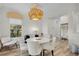 Elegant dining room with a round white table, chandelier, and white chairs at 11401 Camden Park Dr, Windermere, FL 34786