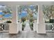 Inviting front porch with white columns and a view of a tree-lined street at 11401 Camden Park Dr, Windermere, FL 34786