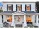 Inviting front porch with white columns and cozy seating at 11401 Camden Park Dr, Windermere, FL 34786