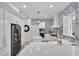 Modern kitchen with white cabinets, quartz countertops, and a patterned tile backsplash at 11401 Camden Park Dr, Windermere, FL 34786