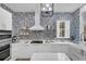 Bright kitchen featuring white cabinetry, patterned tile, and stainless steel appliances at 11401 Camden Park Dr, Windermere, FL 34786