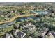 An aerial view of an estate surrounded by trees and landscaping, near a beautiful pond at 11413 Camden Park Dr, Windermere, FL 34786
