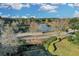 Aerial view of a serene pond with a bridge, surrounded by lush trees and landscaping at 11413 Camden Park Dr, Windermere, FL 34786