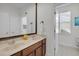 Full bathroom featuring double sinks, wood cabinets, and a window at 11413 Camden Park Dr, Windermere, FL 34786