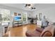 Light-filled bedroom featuring hardwood floors, two windows, and a relaxing seating area at 11413 Camden Park Dr, Windermere, FL 34786