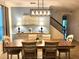 Elegant dining room featuring a modern chandelier, stylish sideboard, and staircase access at 11413 Camden Park Dr, Windermere, FL 34786