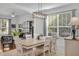 Bright dining area featuring a modern light fixture, large window, and a spacious table with seating for Gathering gatherings and entertaining at 11413 Camden Park Dr, Windermere, FL 34786