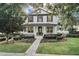 Charming two-story home with a well-manicured front yard, inviting curb appeal, and a cozy front porch with beautiful landscaping at 11413 Camden Park Dr, Windermere, FL 34786