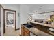 Modern kitchen with dark countertops and an open view to the bonus room at 11413 Camden Park Dr, Windermere, FL 34786