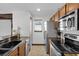 Modern kitchen with stainless steel appliances and granite counters at 11413 Camden Park Dr, Windermere, FL 34786