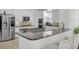Modern kitchen with white cabinets, stainless steel appliances, granite countertops, a center island and a breakfast bar at 11413 Camden Park Dr, Windermere, FL 34786
