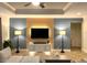 Stylish living room with a modern media center, recessed lighting, and neutral color palette at 11413 Camden Park Dr, Windermere, FL 34786