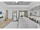 Bright living room featuring a large sectional sofa, tile floors, and easy access to the kitchen and outdoor patio at 11413 Camden Park Dr, Windermere, FL 34786