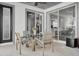 Covered patio with a glass table, seating, and view of the home's interior at 11413 Camden Park Dr, Windermere, FL 34786