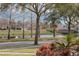 Scenic view of a tranquil pond surrounded by mature trees and lush greenery at 11413 Camden Park Dr, Windermere, FL 34786