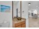 Elegant powder room with granite countertop, bowl sink, and decorative mirror near the kitchen and bedroom at 11413 Camden Park Dr, Windermere, FL 34786