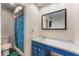 Bathroom with blue vanity and shower/tub combo at 11729 Whitewing Ct, Orlando, FL 32837