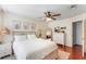 Bright bedroom with ceiling fan and wood-look flooring at 11729 Whitewing Ct, Orlando, FL 32837