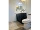 Bathroom with dark vanity, a toilet, and light gray flooring at 1216 Windward Dr, Apopka, FL 32703