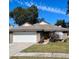 One-story brick house with a white garage door and green lawn at 1216 Windward Dr, Apopka, FL 32703