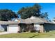 Brick house with white garage door and landscaped lawn at 1216 Windward Dr, Apopka, FL 32703