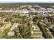 Expansive aerial view featuring residential area, mature trees, road and commercial buildings at 1312 Surf Ave, Apopka, FL 32703