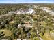 Residential houses surrounded by mature trees, commercial buildings, and local businesses at 1312 Surf Ave, Apopka, FL 32703