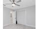 Bedroom featuring a ceiling fan, new flooring, and a double closet with folding doors at 1312 Surf Ave, Apopka, FL 32703