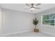 Bedroom featuring new wood-look flooring, a ceiling fan, and views to the backyard at 1312 Surf Ave, Apopka, FL 32703