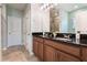 Double vanity bathroom with granite countertop and large mirror at 14694 Seton Creek Blvd, Winter Garden, FL 34787