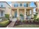 Two-story house with front porch, teal door, and well-maintained landscaping at 14694 Seton Creek Blvd, Winter Garden, FL 34787