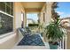 Relaxing front porch with rocking chairs, potted plants, and patterned rug at 14694 Seton Creek Blvd, Winter Garden, FL 34787