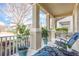 Inviting front porch with rocking chairs, potted plants, and a view of the neighborhood at 14694 Seton Creek Blvd, Winter Garden, FL 34787