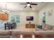 Spacious living room with sectional sofa, large TV, and dining area at 14694 Seton Creek Blvd, Winter Garden, FL 34787