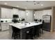 Modern kitchen with large island, white cabinets, and stainless steel appliances at 16368 Orange Seed Ln, Winter Garden, FL 34787