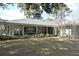 Expansive backyard featuring a covered patio, lush greenery, and mature trees providing ample shade at 1821 Stanley St, Longwood, FL 32750