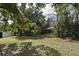 Large, grassy backyard featuring mature trees, providing plenty of shade and privacy at 1821 Stanley St, Longwood, FL 32750