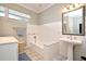 Bright bathroom with white tile, a soaking tub, and vanity sink at 1821 Stanley St, Longwood, FL 32750