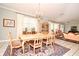 Dining room boasts natural light, a chandelier, and flows into the living area for easy entertaining at 1821 Stanley St, Longwood, FL 32750