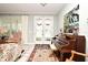 Bright entryway with piano, French doors and area rug at 1821 Stanley St, Longwood, FL 32750