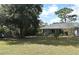 Exterior view of the home with a large backyard and mature trees at 1821 Stanley St, Longwood, FL 32750