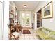 Hallway with a bookshelf and a door to the patio area, a desk, and plenty of wall decor at 1821 Stanley St, Longwood, FL 32750