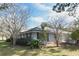 Single story home with grey siding and a green lawn at 1821 Stanley St, Longwood, FL 32750